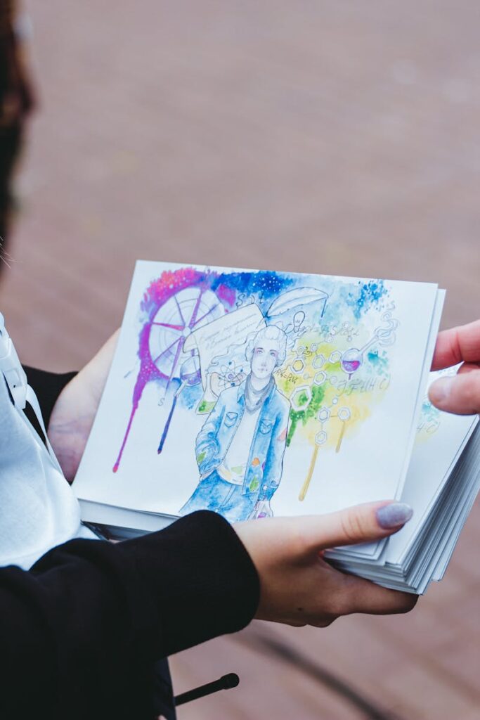 A vibrant watercolor illustration held by an artist displaying creative expression.