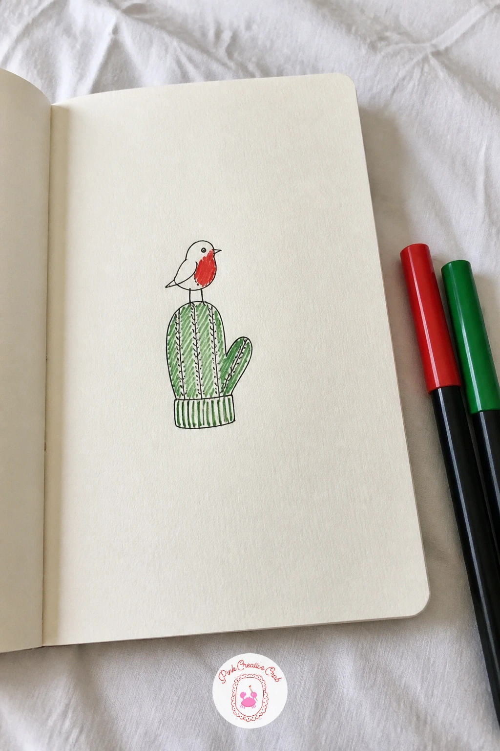 Robin On A Mitten — Pair a bird with an object for a robin on a mitten, one of the gentlest compositions on this list. Christmas card doodles