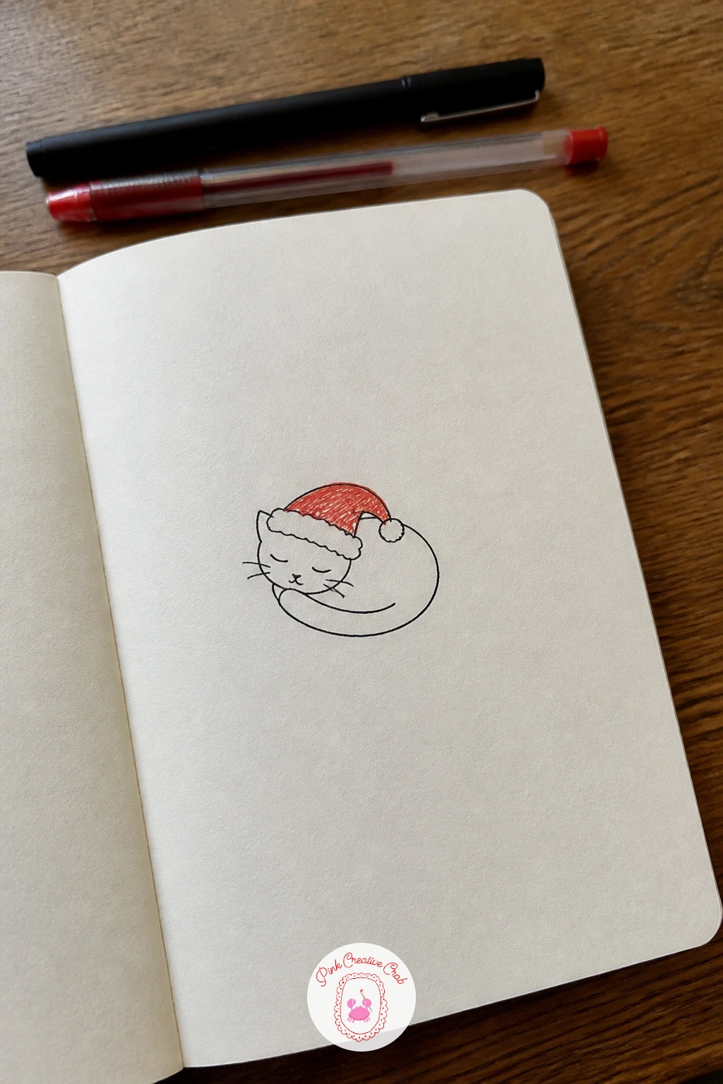 Sleeping Cat In A Santa Hat — Move into animals with a cat curled into a simple comma shape, head tucked down near its tail. Simple christmas doodles