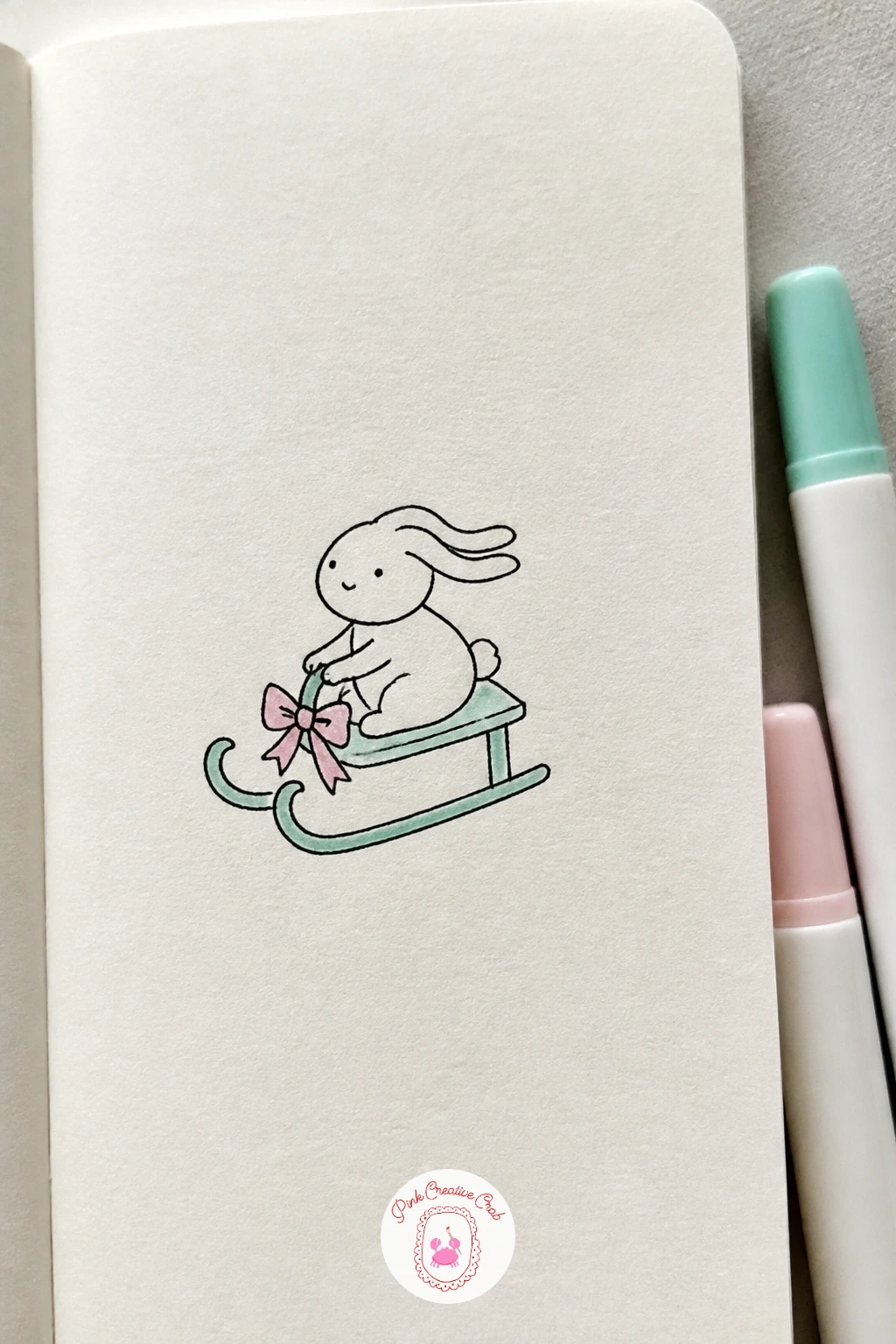 Bunny on a Sled — Bunny on a Sled adds a simple prop beneath an already familiar round bunny shape for a sense of fun movement. Christmas drawing ideas easy