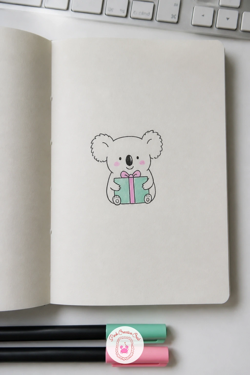 Koala With a Gift — Koala With a Gift gives you a round fuzzy face with large ears as the main feature, paired with a small wrapped present held in its lap.