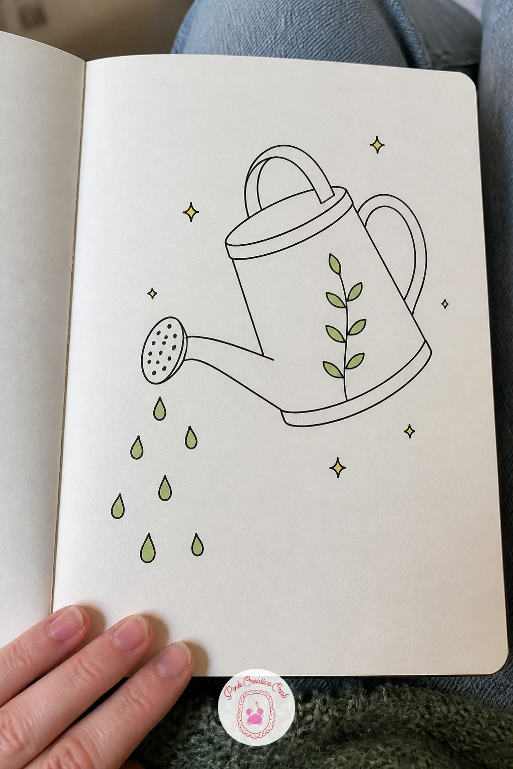 Watering Can With Drops — Carry the gardening thread forward with a watering can, built from one rounded body, a curved handle arching over the top, and a long