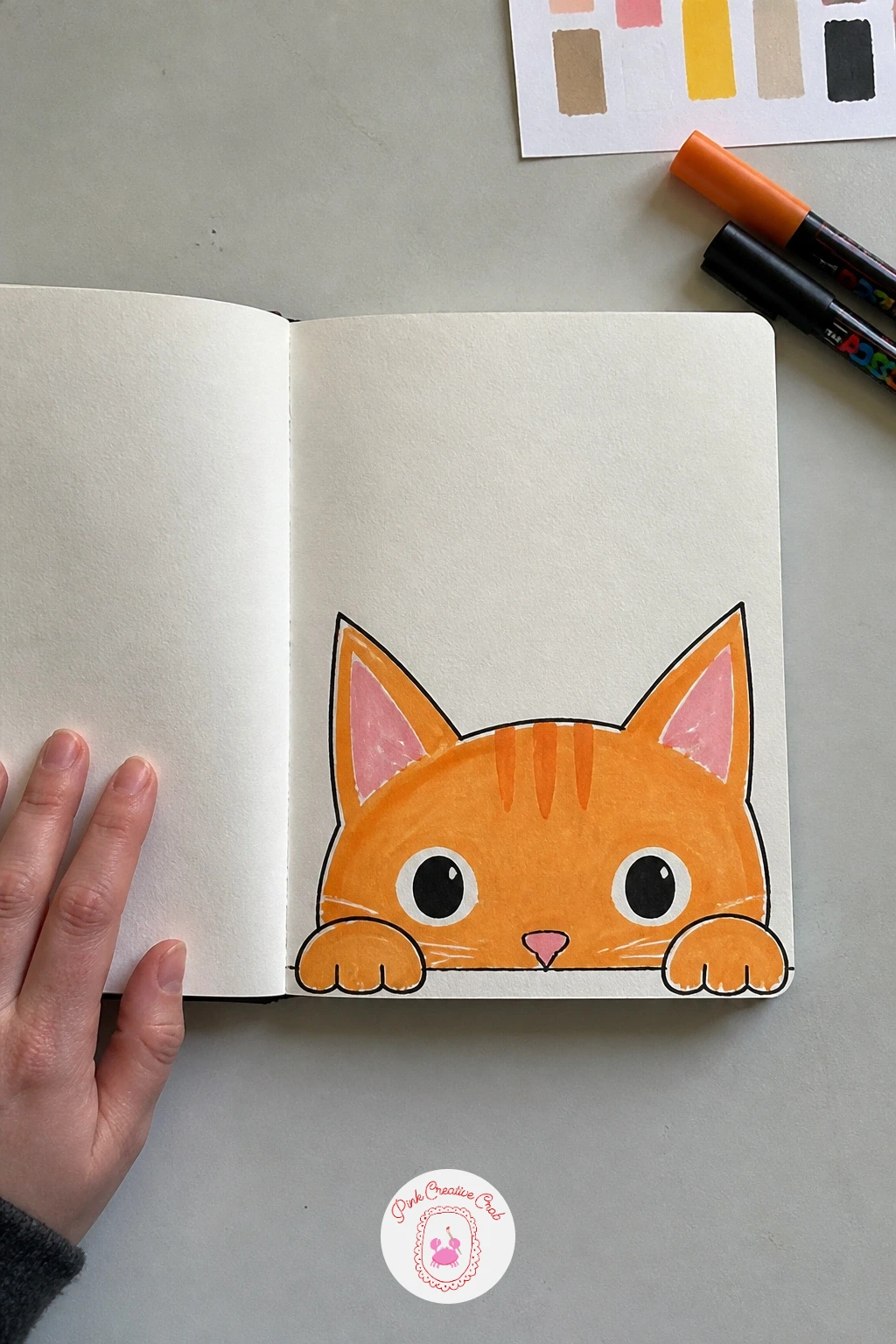 Cat Peeking Over the Edge — A cat peeking over the edge turns the bottom of the cover into a little stage, with just the top of a head and two ears showing