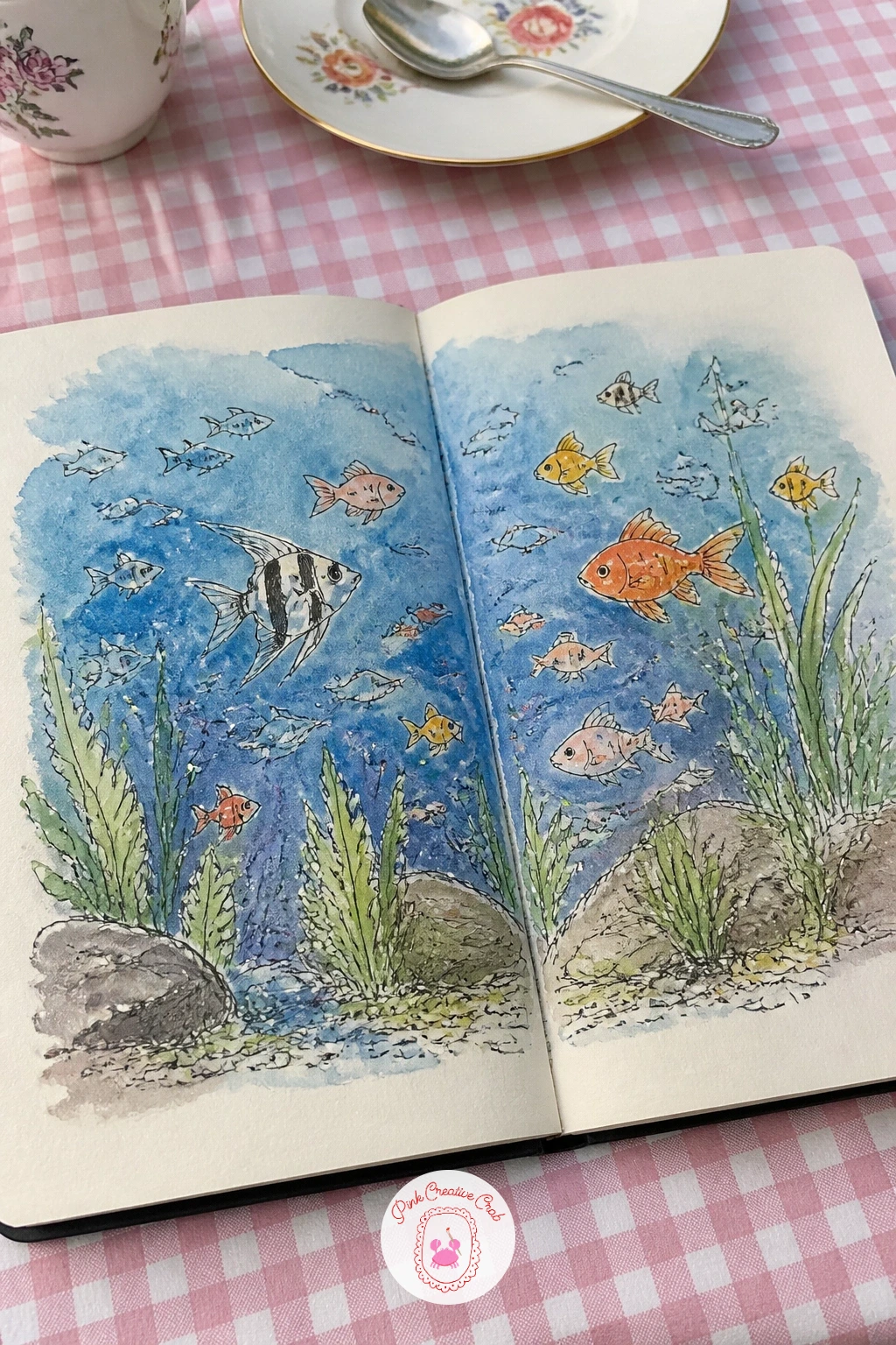 Aquarium Wall Of Fish — Treat both pages as one tall viewing window, a wash of deep blue water running edge to edge with a handful of fish, a few plants and