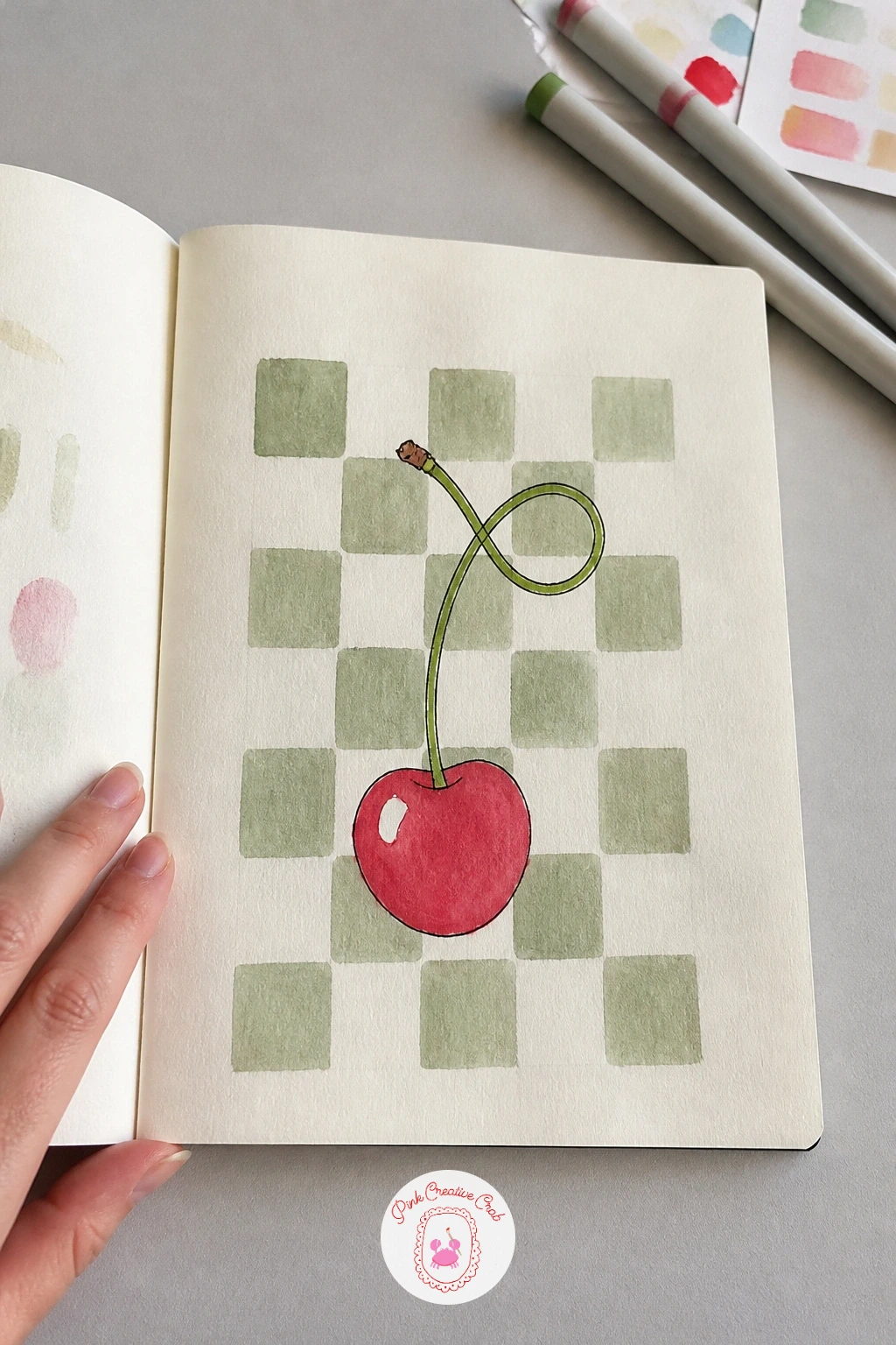 Checkerboard Cherry — Rule a light grid of evenly sized squares across the page, then fill in alternating squares with a flat wash, keeping each square painted