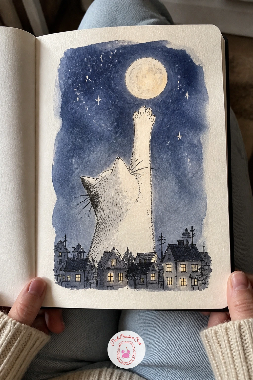 Cat Reaching for the Moon Over the Town — Reach a cat's paw high above a sleepy little town toward a full moon the way it would bat at a light fixture. Cool
