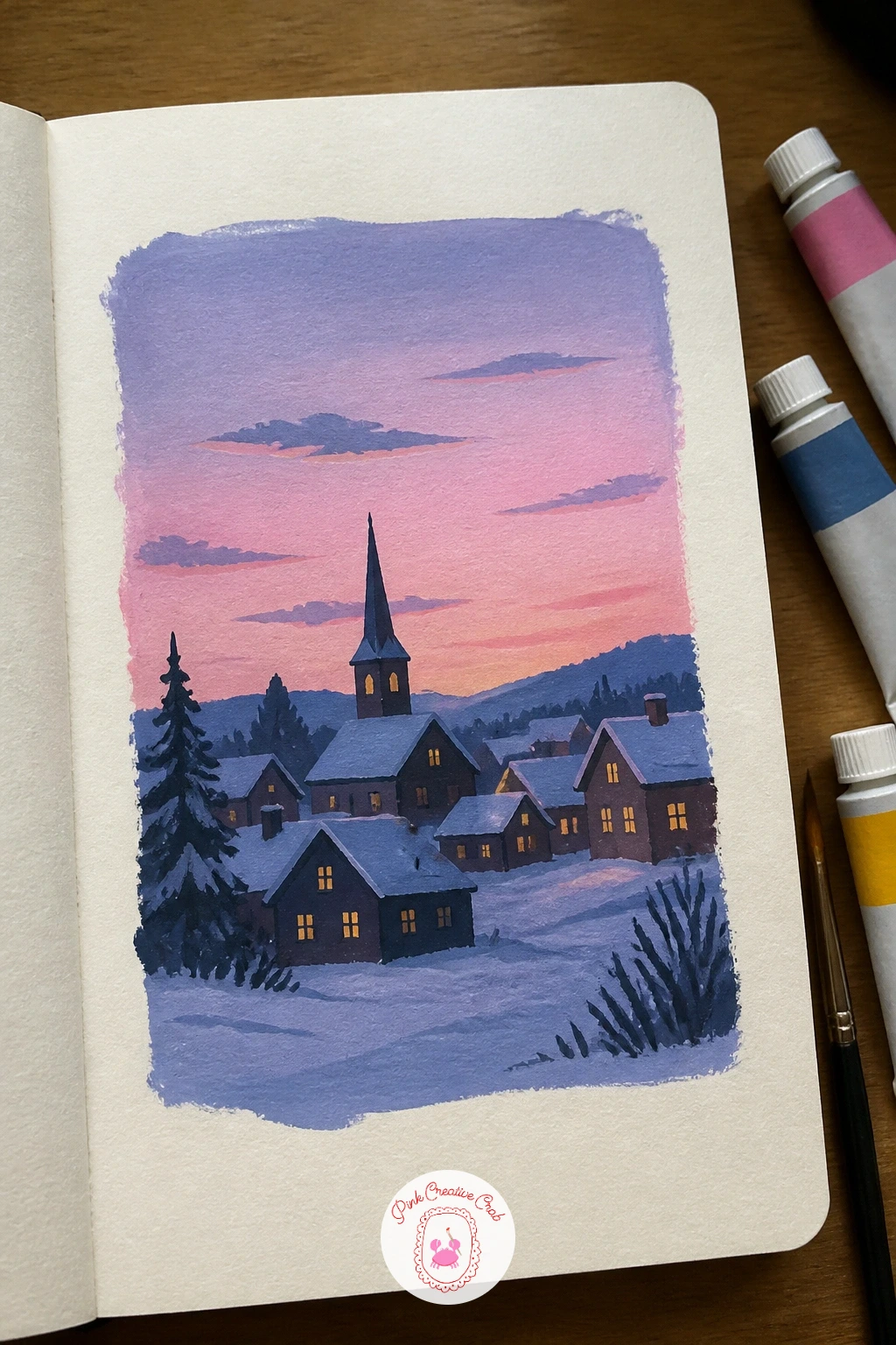 Snowy Village At Pastel Dusk — Carry that warm glow outdoors for a snowy village at pastel dusk, little houses with lit windows against a softening sky.