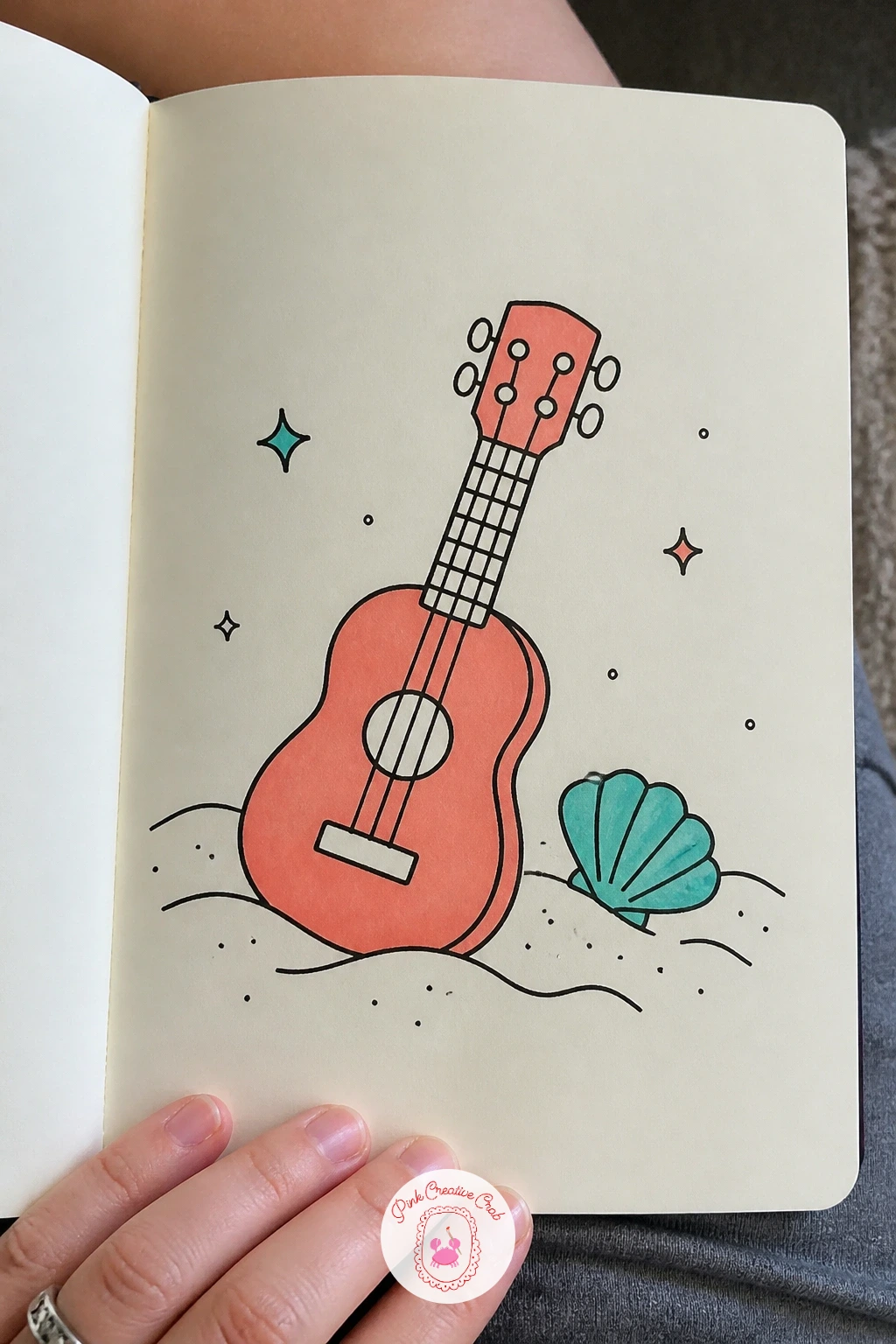 Ukulele On Sand — A ukulele resting on sand brings in a beachy little scene without much extra work. Music doodle