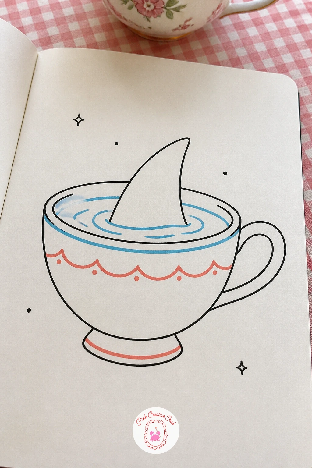 Shark Fin In A Teacup — Move from a full shark to just a hint of one: a shark fin poking out of a teacup, as if something enormous is hiding in your afternoon