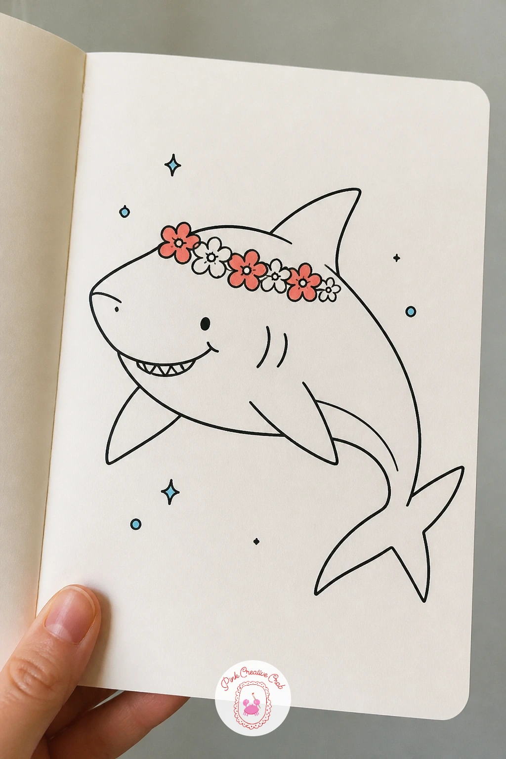Shark With A Flower Crown — Soften the shark shape with a flower crown sitting across the top of its head, a nice contrast between the sharp teeth below and