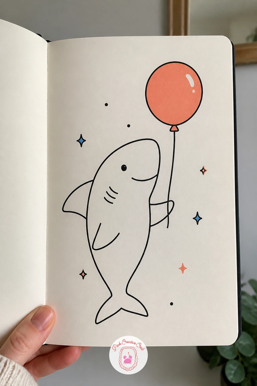 Shark Holding A Balloon — Keep this one light and simple: a shark holding a balloon, one front fin curled around a string that trails down to a round balloon.
