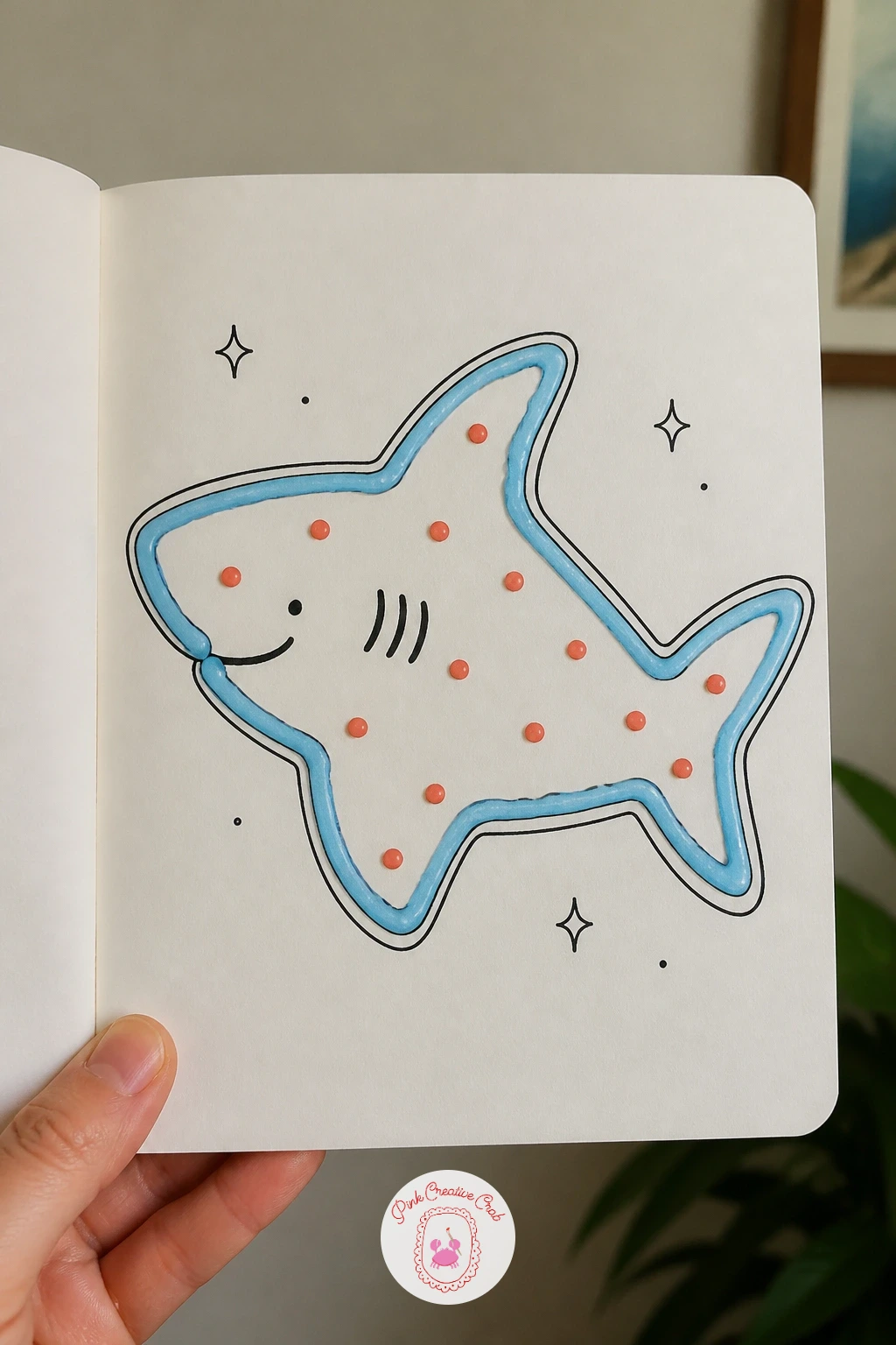 Shark-Shaped Cookie With Icing — Turn the shark into a treat for a shark-shaped cookie with icing, flat and simple like something cut from dough. Shark doodle