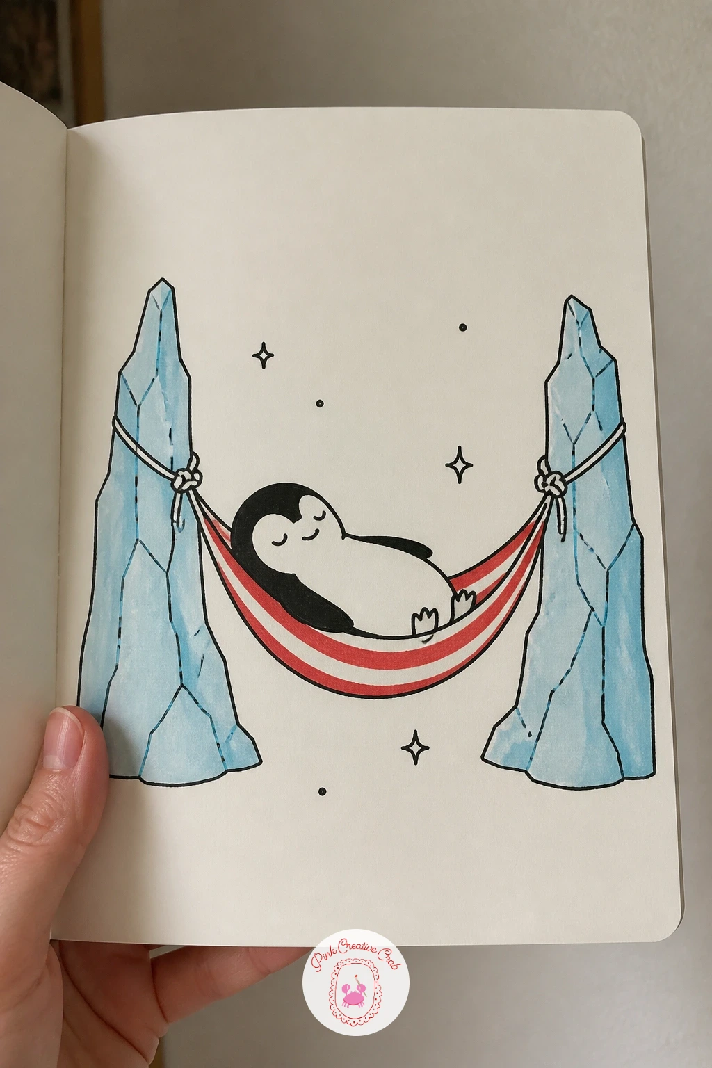 Penguin Napping In An Iceberg Hammock — Draw two icebergs first, simple jagged triangular shapes with flat tops, spaced apart on the page, then string a